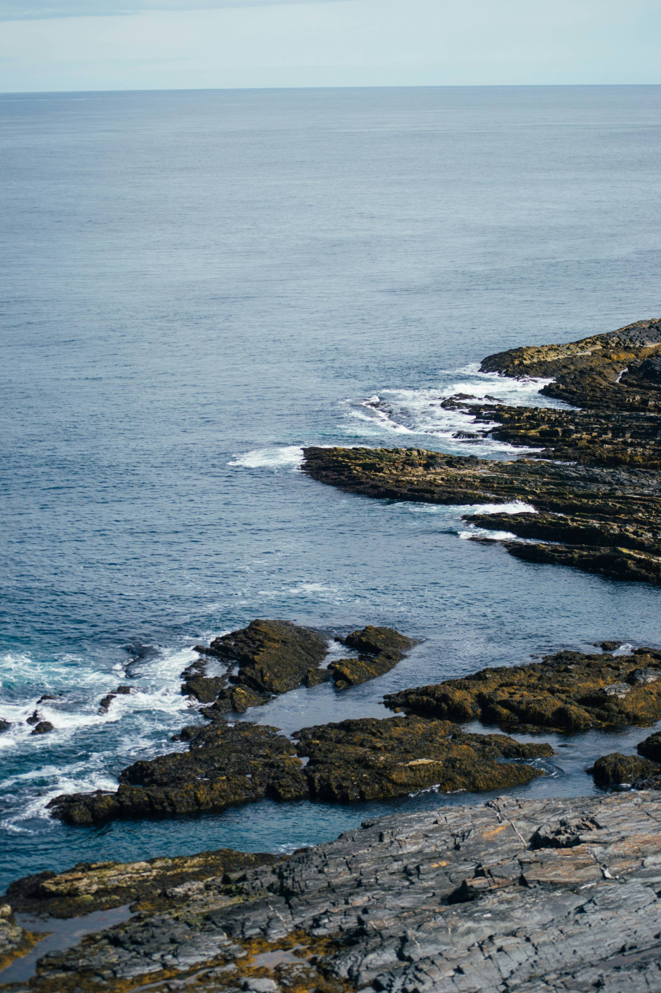 A view of the ocean from a rocky cliff