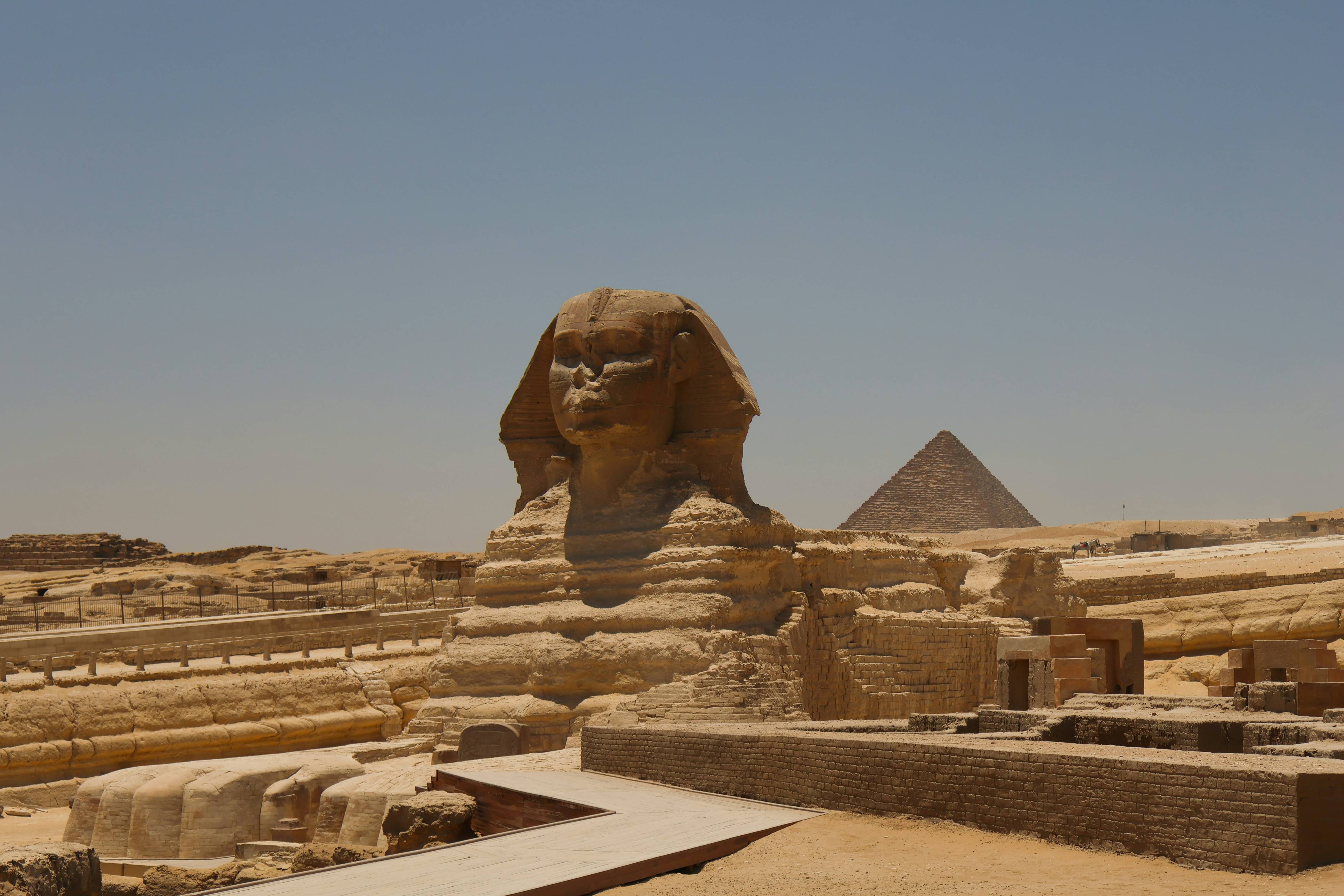 A large sphinx statue in the middle of a desert
